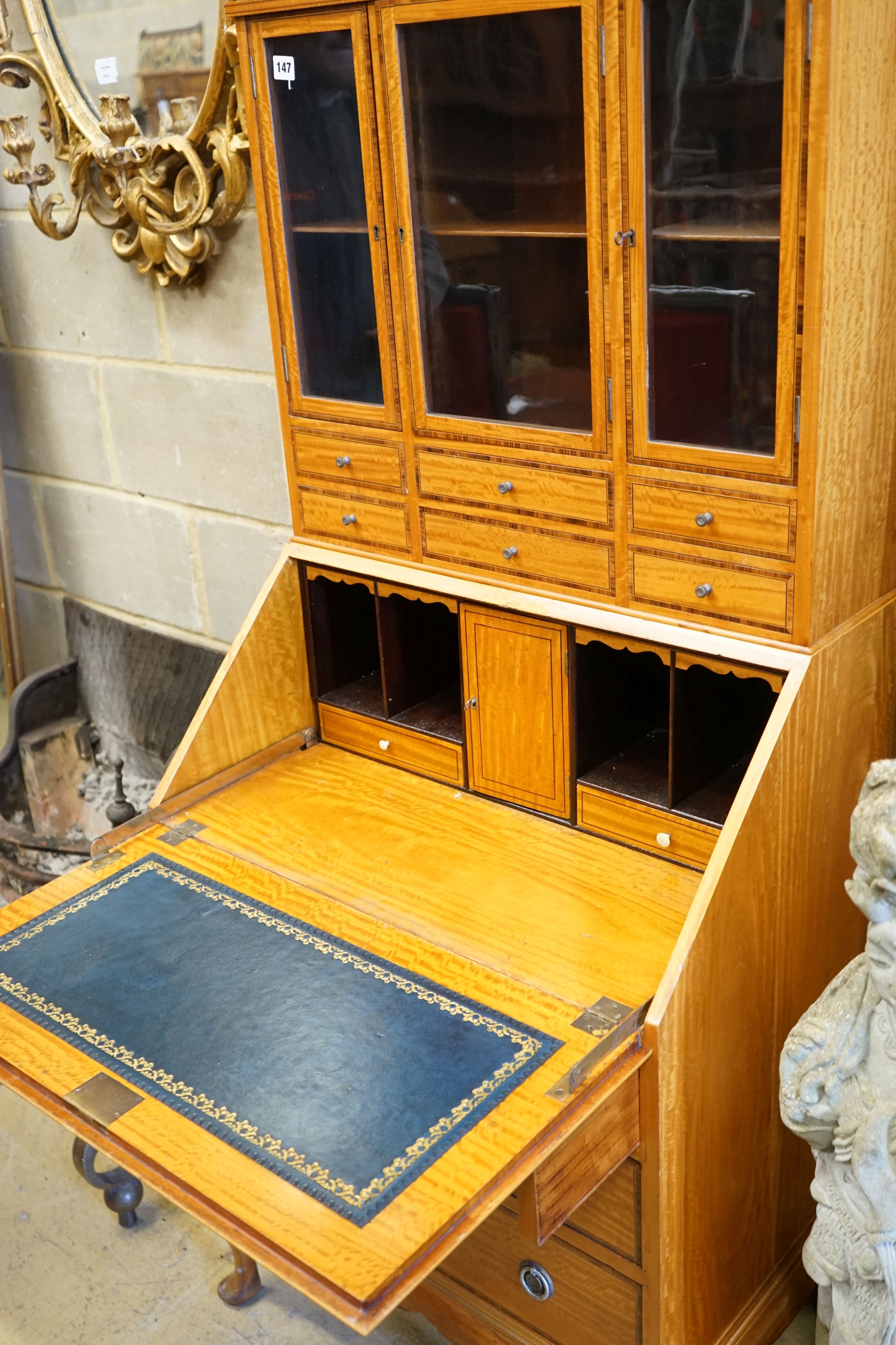 An Edwardian satinwood bureau bookcase, width 69cm, depth 47cm, height 160cm (lock a.f)